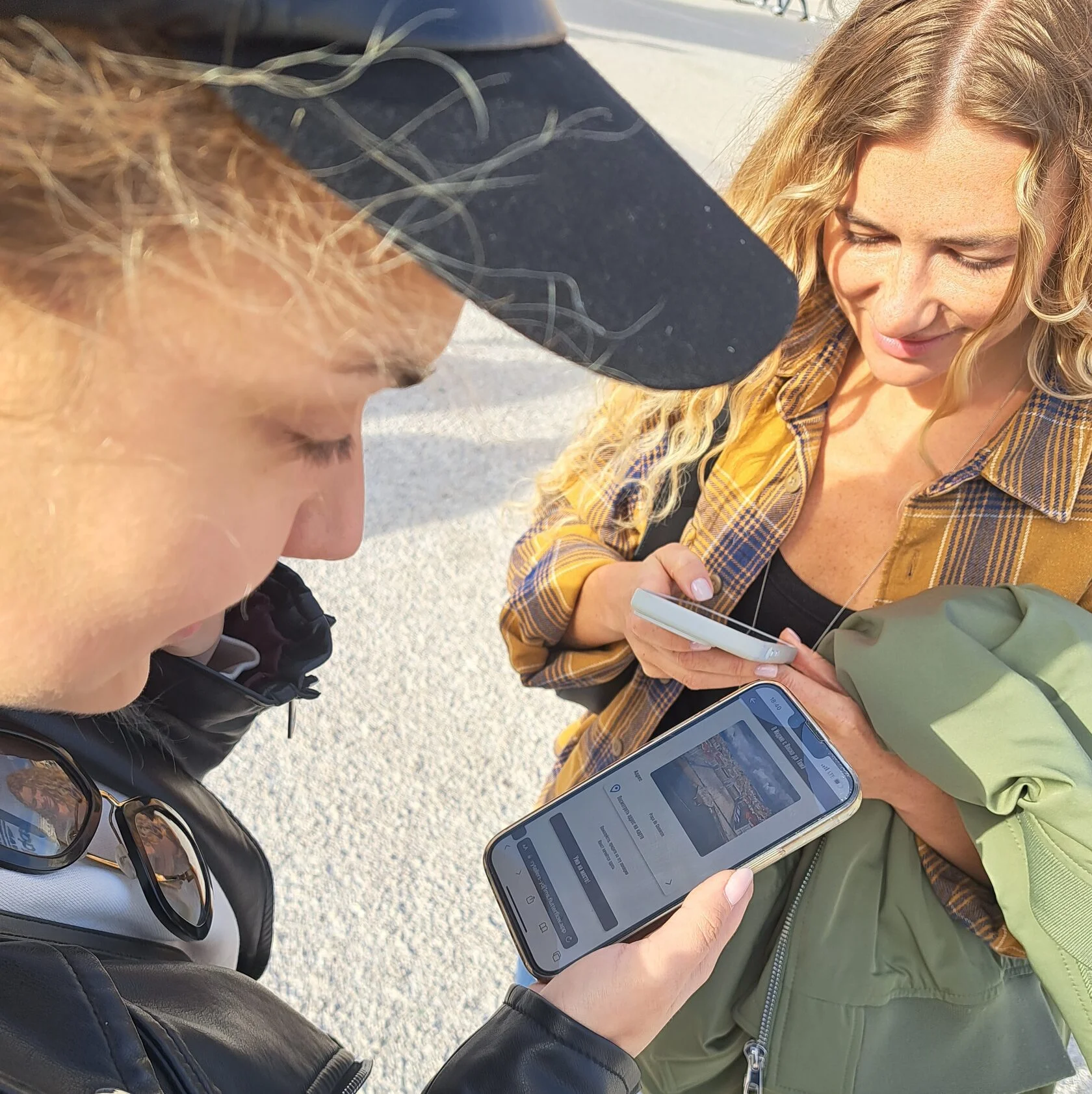 Two travellers following the tour on a phone