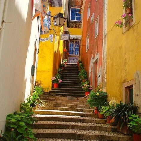 Sunlit yellow stairway in old Lisbon
